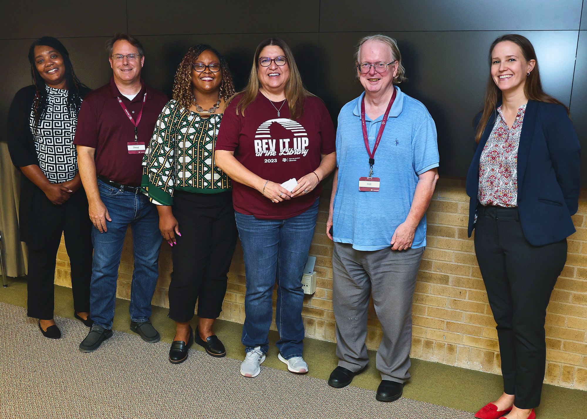 Staff who have worked at Texas A&M University from 25 to 45 years standing with the University Librarian.